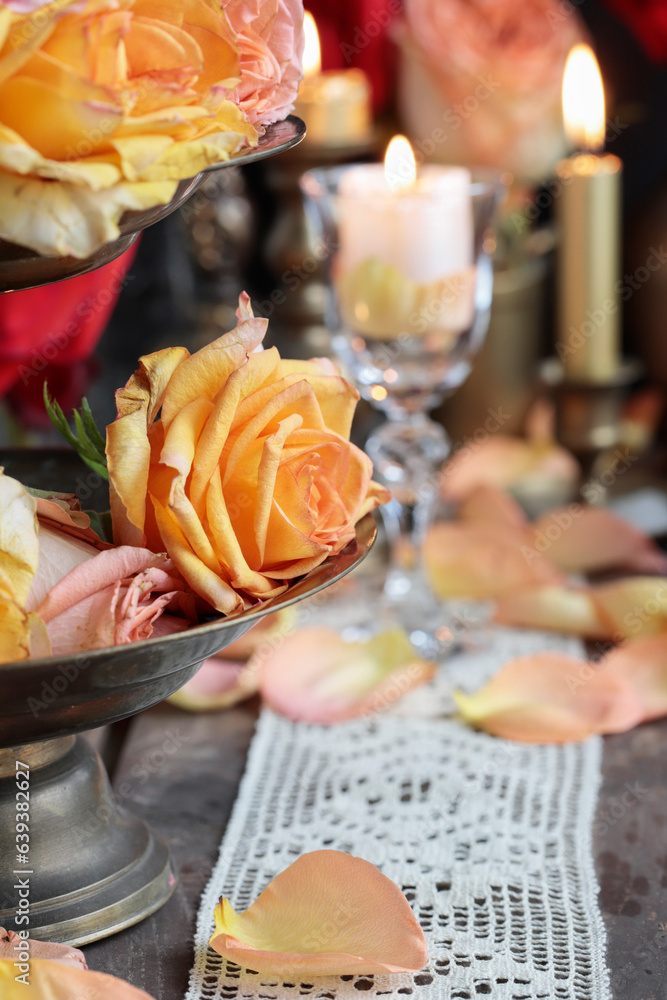 Romantic table decoration with roses and candles. Valentine's Day decorating ideas.