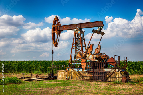 Oil pump in the corn field  photo