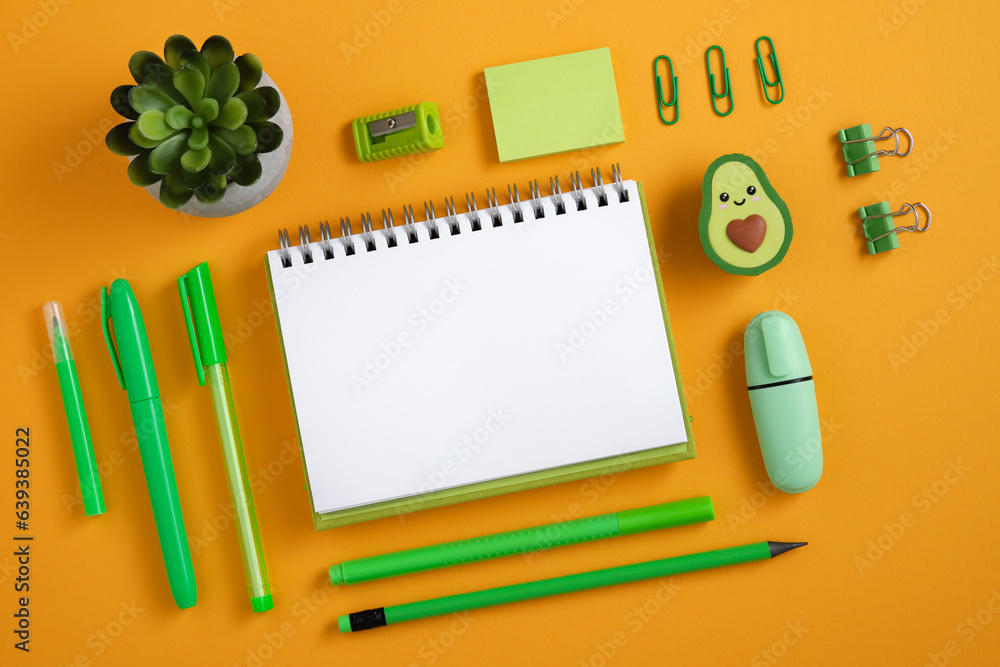 Empty page with green pen, pencil and marker on yellow background. Eraser in the form of avocado. Flatly. Empty page with green pen, pencil and marker on yellow background. Eraser in the form of avocado. Flatly.