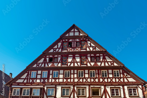 Frontfassade eines alten Fachwerkhauses im alemannischen Fachwerkstil mit blauem, wolkenlosen Himmel photo