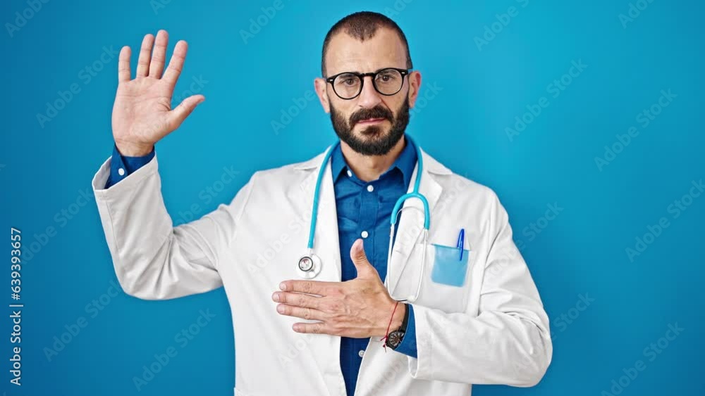 Young hispanic man doctor making an oath with hand on chest over isolated blue background Young hispanic man doctor making an oath with hand on chest over isolated blue background