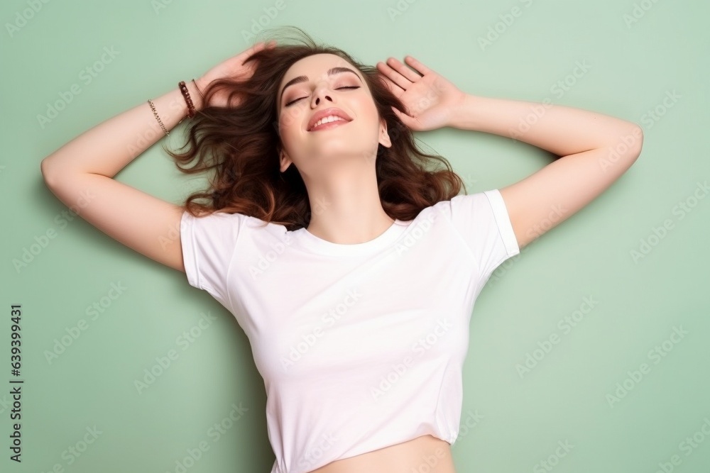 female lying down on back wearing white tshirt on green background for mock up female lying down on back wearing white tshirt on green background for mock up