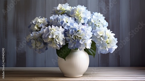 The interior of the home features a decorative vase adorned with hydrangeas on a wooden table.