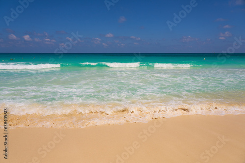 Waves with foam on the Caribbean coast in Mexico.