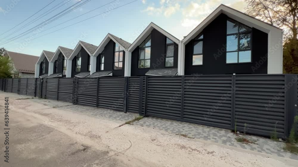 Row of new just built townhouses in the suburbs. Side view. Extreme wide angle shot Row of new just built townhouses in the suburbs. Side view. Extreme wide angle shot