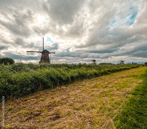 Iconic and historical wooden Dutch windmills. Built in the 1700's to keep water out of the low-lying areas, Kinderdijk, Netherlands has been a UNESCO World Heritage Site since 1997. 