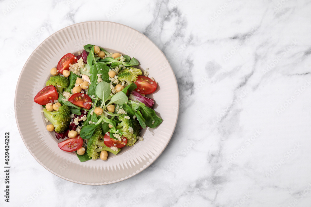 Healthy meal. Tasty salad with quinoa, chickpeas and vegetables on white marble table, top view with space for text Healthy meal. Tasty salad with quinoa, chickpeas and vegetables on white marble table, top view with space for text