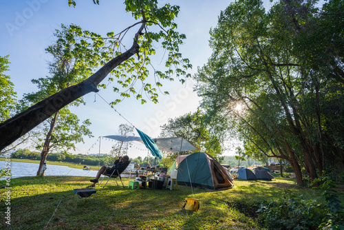 Tableau sur toile Outdoor camping tent with tarp or flysheet on green grass and light morning, vacation picnic on holiday relax near lake, Tourism concept