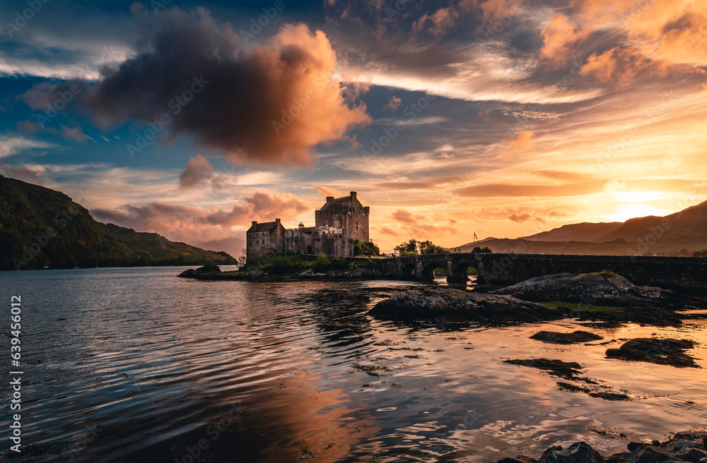 The view of the Eilean Donan Castle under the dramatic sky in the sunset