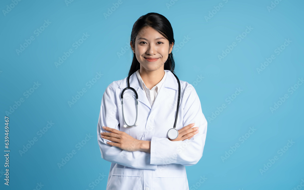 image of asian female doctor posing on blue background image of asian female doctor posing on blue background