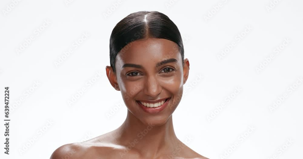 Face, skin and woman with wink, beauty and natural cosmetics for wellness on white background. Portrait of Indian model, flirt and skincare with dermatology in studio, headshot with mockup space Face, skin and woman with wink, beauty and natural cosmetics for wellness on white background. Portrait of Indian model, flirt and skincare with dermatology in studio, headshot with mockup space