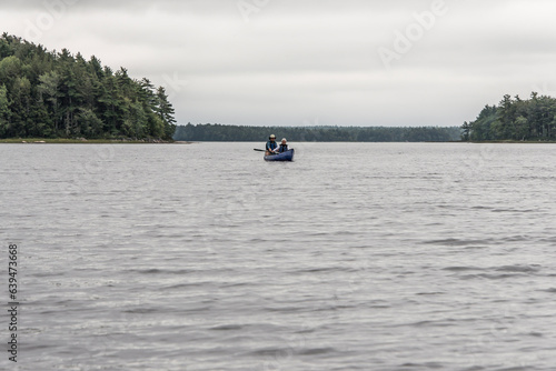 Canoe ride on river and islands in morning mist at Kejimkujik National Park Designated Wilderness Nova Scotia Canada