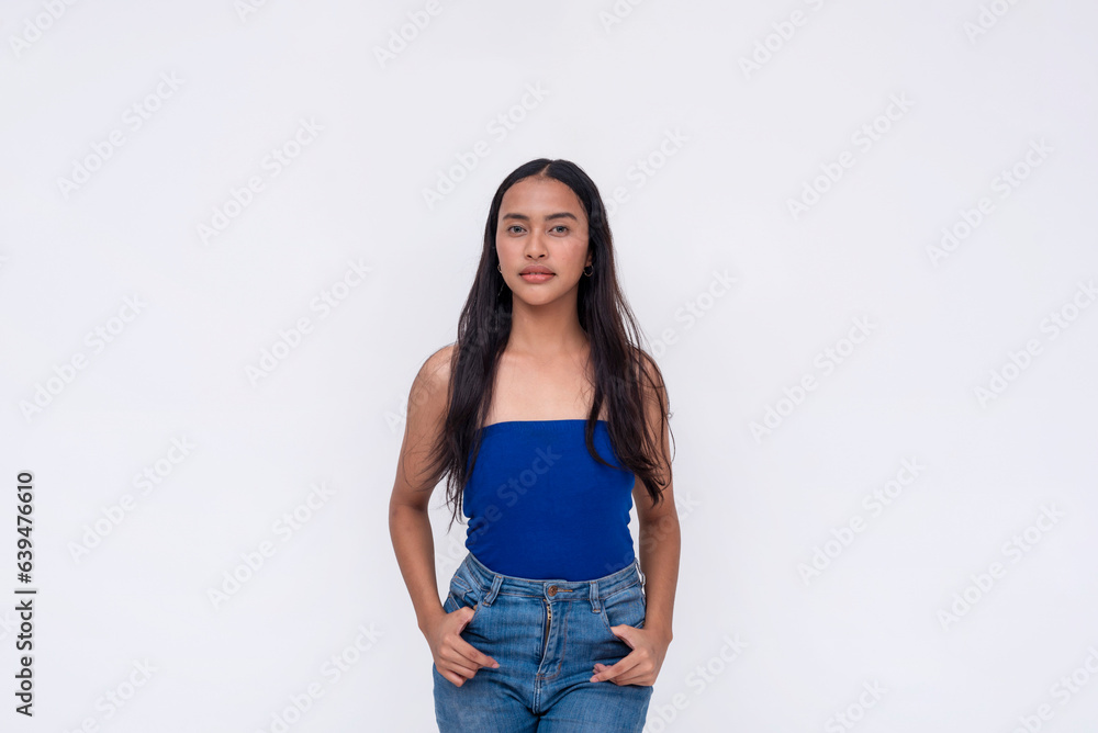 A pensive young Filipino woman in a blue tube top and jeans. Isolated on a white background. A pensive young Filipino woman in a blue tube top and jeans. Isolated on a white background.
