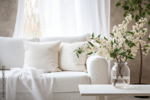 Close up of a sofa, coffee table and plants in a minimalistic living room staging