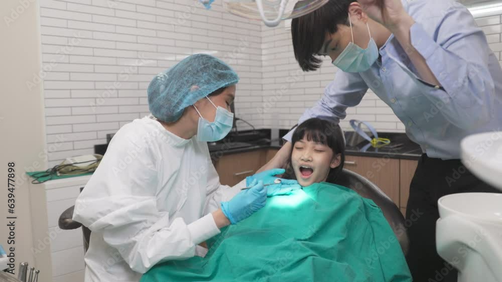 Children's dentistry for healthy teeth .Close-up happy little child asian girl smiles looking at camera, sitting in dentist's chair, receiving dental. Children's dentistry for healthy teeth .Close-up happy little child asian girl smiles looking at camera, sitting in dentist's chair, receiving dental.