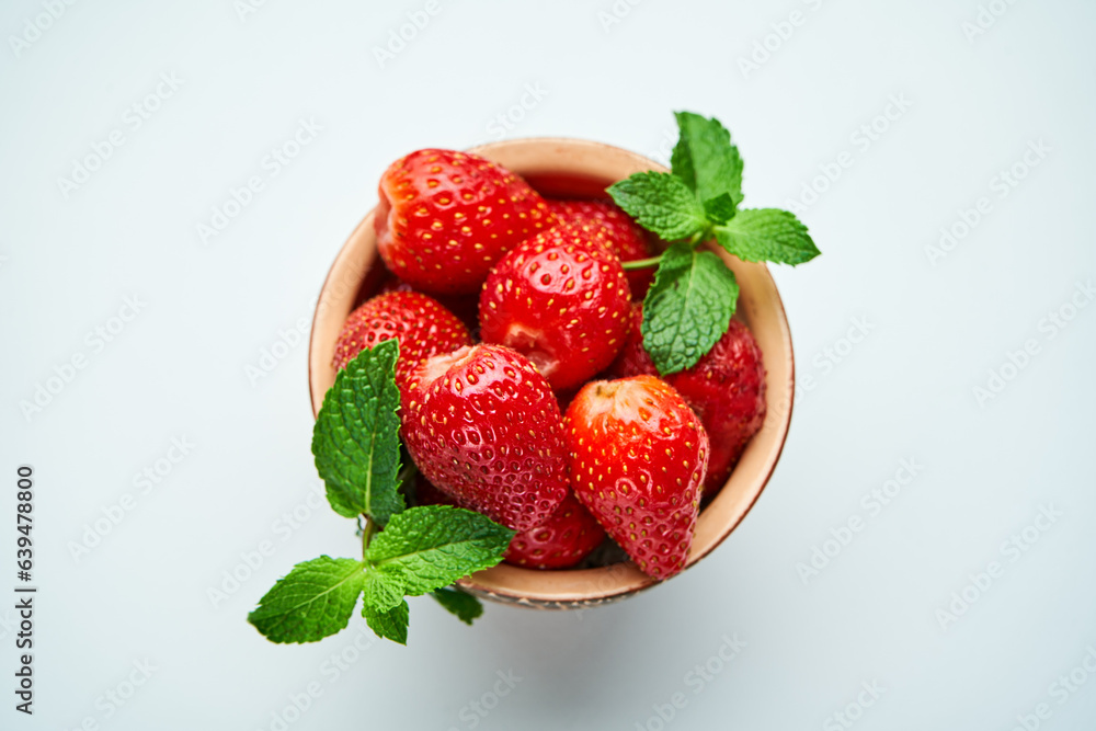 strawberries in a ceramic bowl on top strawberries in a ceramic bowl on top