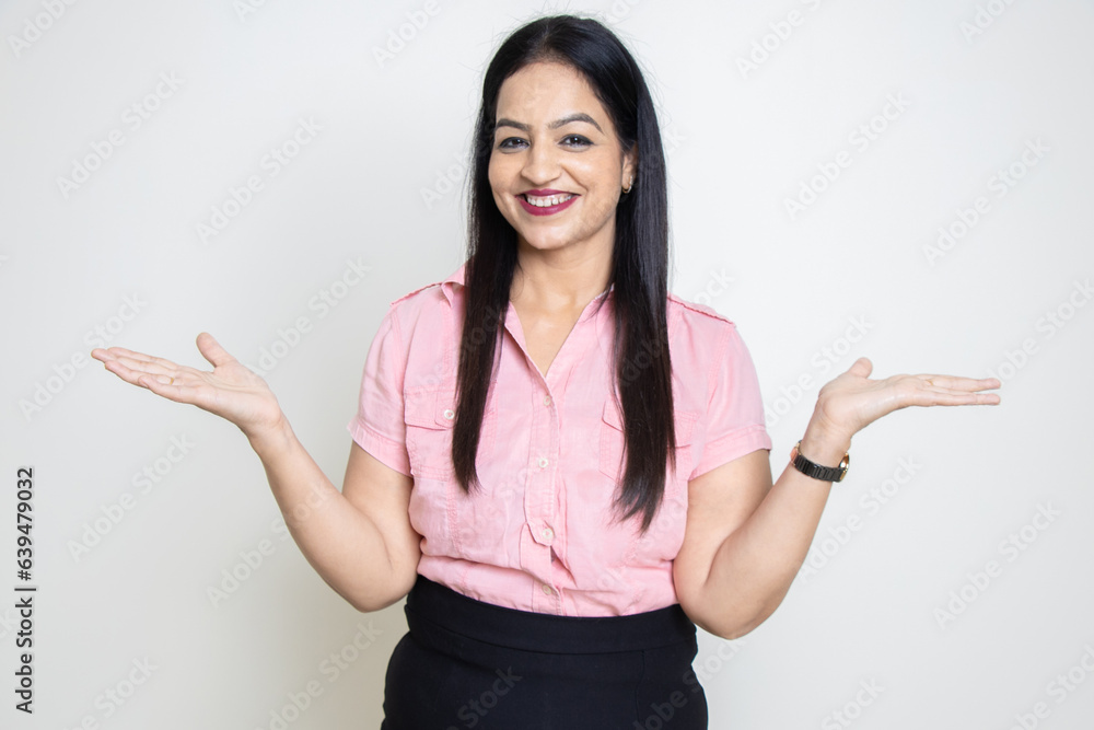 Happy young indian ssman wearing pink formal shirt with empty hands gesture isolated over white background. Look here, Put Advertisement and promotion. Happy young indian ssman wearing pink formal shirt with empty hands gesture isolated over white background. Look here, Put Advertisement and promotion.