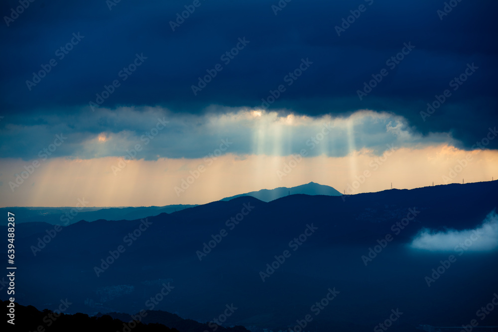 Catching the Light: Crepuscular Rays Amidst Mountain's Ever-Changing Clouds. The Wufenshan Weather Radar Station stands on the top of the mountain. Taiwan