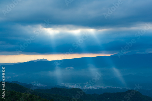 Heavenly Glows: Watch Crepuscular Rays amidst Transforming Clouds on the Peak. The Wufenshan Weather Radar Station stands on the top of the mountain. Taiwan