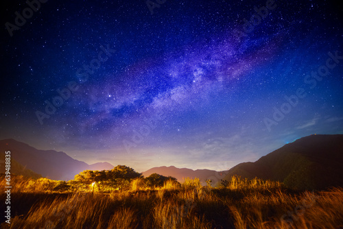 The Milky Way is clearly visible once the fast-moving white clouds disappear. A summer starry sky in Suao Township, Yilan County, eastern Taiwan.