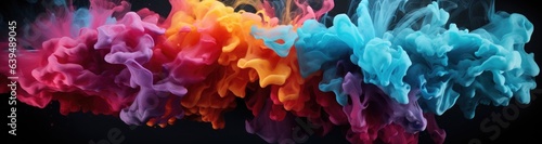 An artistic explosion of colorful smoke creates a vibrant display. Different colors like blue, red, and purple blend, forming a cosmic pattern. The splash of colored liquids gives a fantasy effect.