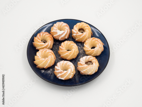Fresh baked round coconut cookies heap top view on white background. © sablinstanislav
