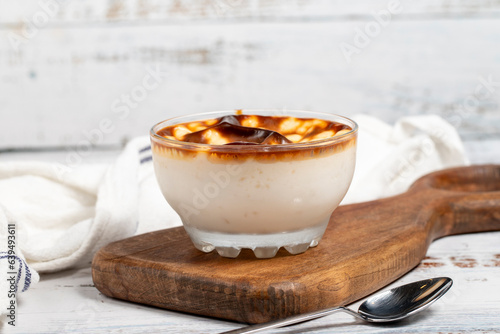 Rice pudding. Fresh delicious rice pudding on a white background. Mild dessert with milk and rice. Traditional Turkish cuisine delicacies. Local name sutlac photo