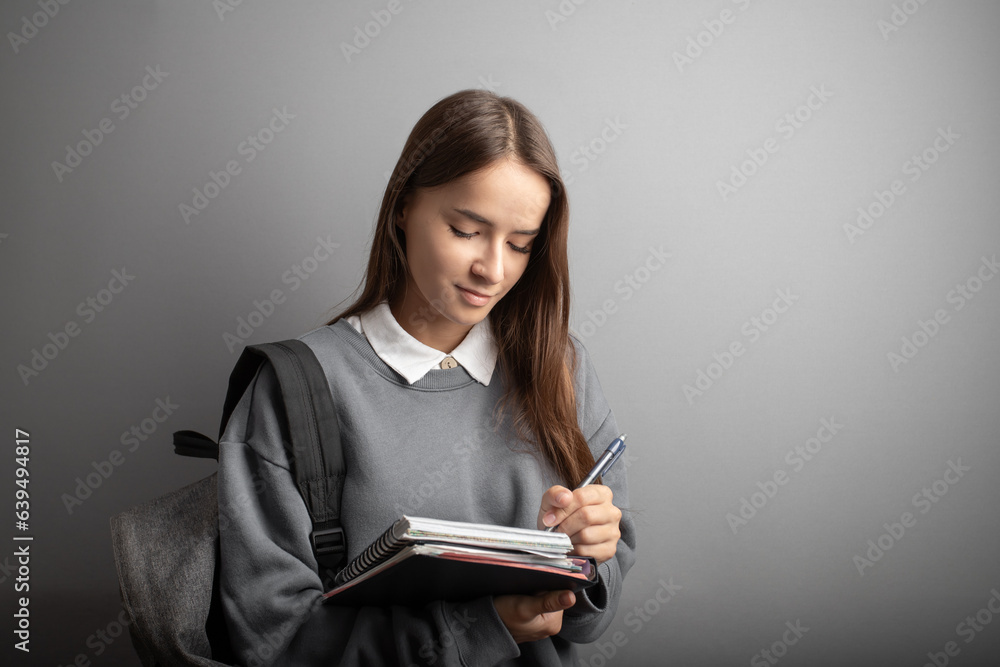 Student girl with a backpack, carrying a notebook and textbook, Teenager studying, Student girl with a backpack, carrying a notebook and textbook, Teenager studying,