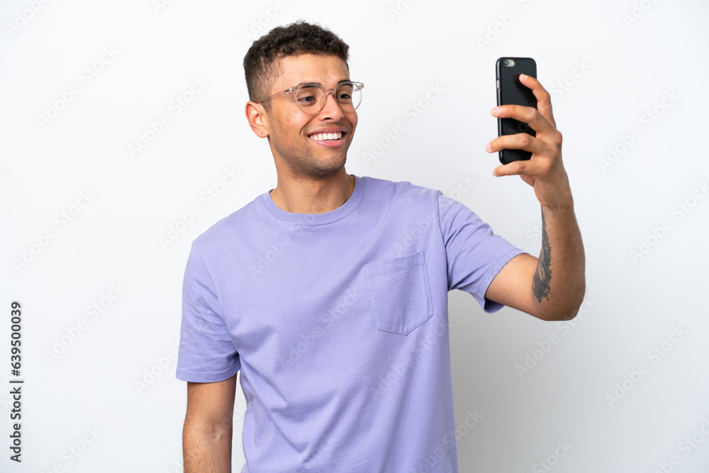 Young caucasian Brazilian man isolated on white background making a selfie Young caucasian Brazilian man isolated on white background making a selfie