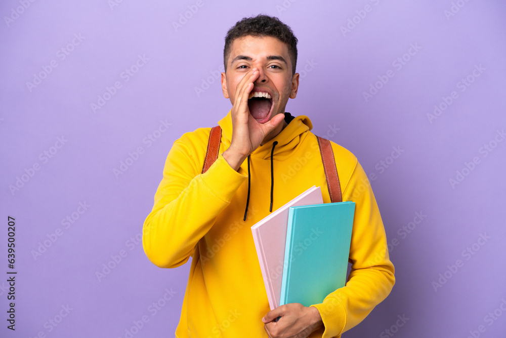 Young student Brazilian man isolated on purple background shouting with mouth wide open Young student Brazilian man isolated on purple background shouting with mouth wide open
