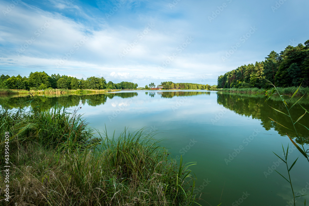 Beautiful lagoon among hills and forests at sunset. Roztocze region, Krasnobrod, Poland