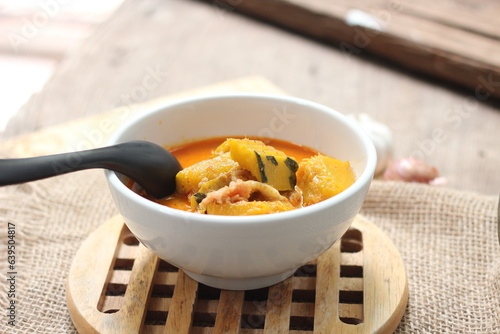 Red Curry Pumpkin with pork served on wooden table, delicious Thai food popular in Thailand, Asia food.