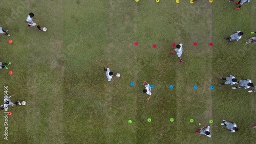 Aerial footage of an amateur football match and practice for 16 year olds in an old stadium. Aerial footage of the process of training and sparring to support children's talents in soccer