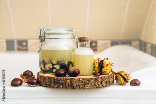 Natural liquid soap and shampoo concept. Soaking horse chestnut, Aesculus hippocastanum in water, which containing natural saponin the cleaning matter and has cleansing properties. Home bathroom.