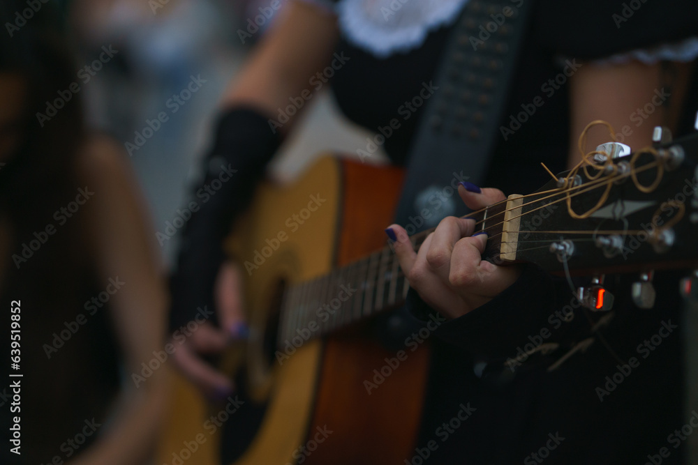 girl plays guitar on the street