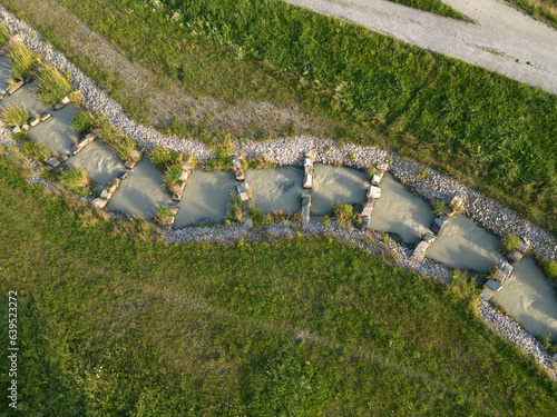 Aerial picture of a fish ladder with top-down view for Inn river hydro power plant  photo