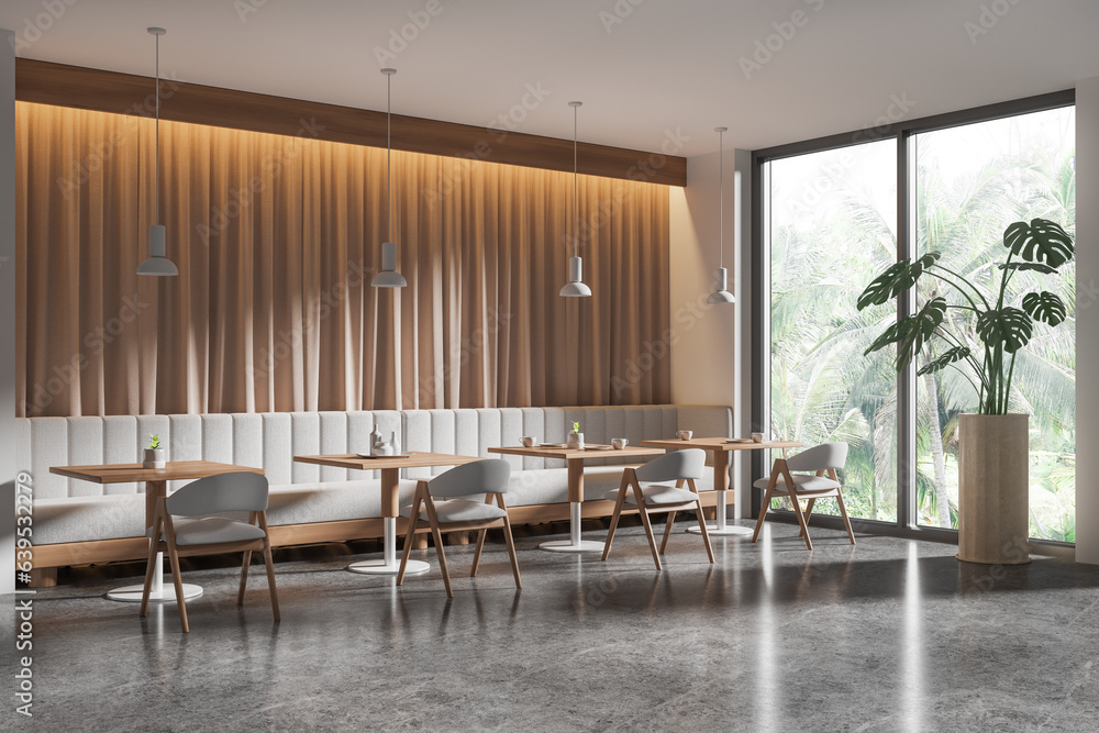 Fototapeta premium Stylish cafe interior with chairs and table, eating space with couch and window