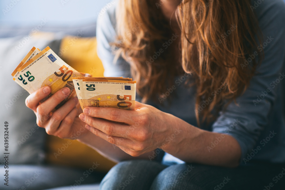 Woman counting Euro cash at home - obrazy, fototapety, plakaty 