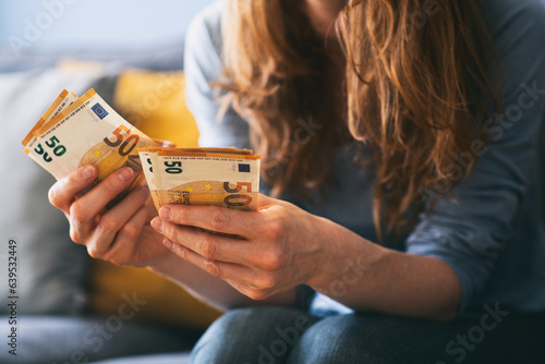 Woman counting Euro cash at home