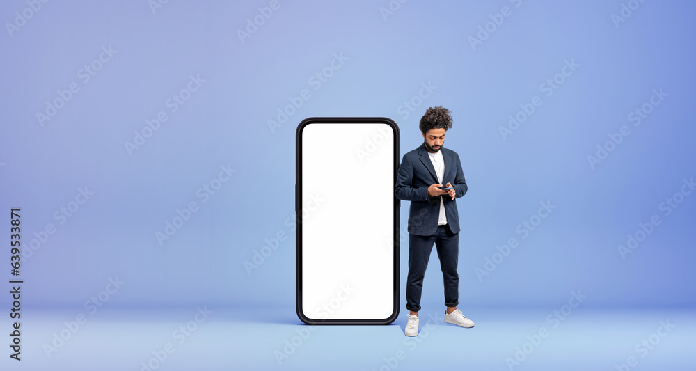 Arab businessman typing in the phone, mock up large display Arab businessman typing in the phone, mock up large display