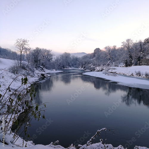 snowy winter landscape along the banks of a river © Ivan