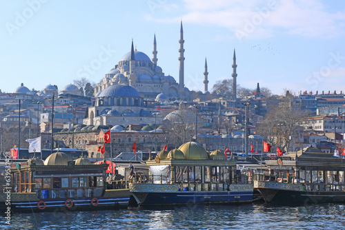 Street Food (Fish-Bread) Boats on the Golden Horn and Suleymaniye Mosque at the Background in Istanbul, Turkey.