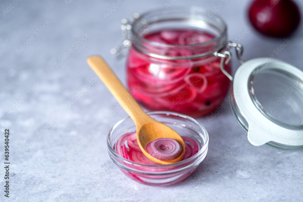 Homemade pickled red onions rings in glass jar on a gray background. Fermented vegetarian food concept. Healthy eating. High quality photo Homemade pickled red onions rings in glass jar on a gray background. Fermented vegetarian food concept. Healthy eating. High quality photo