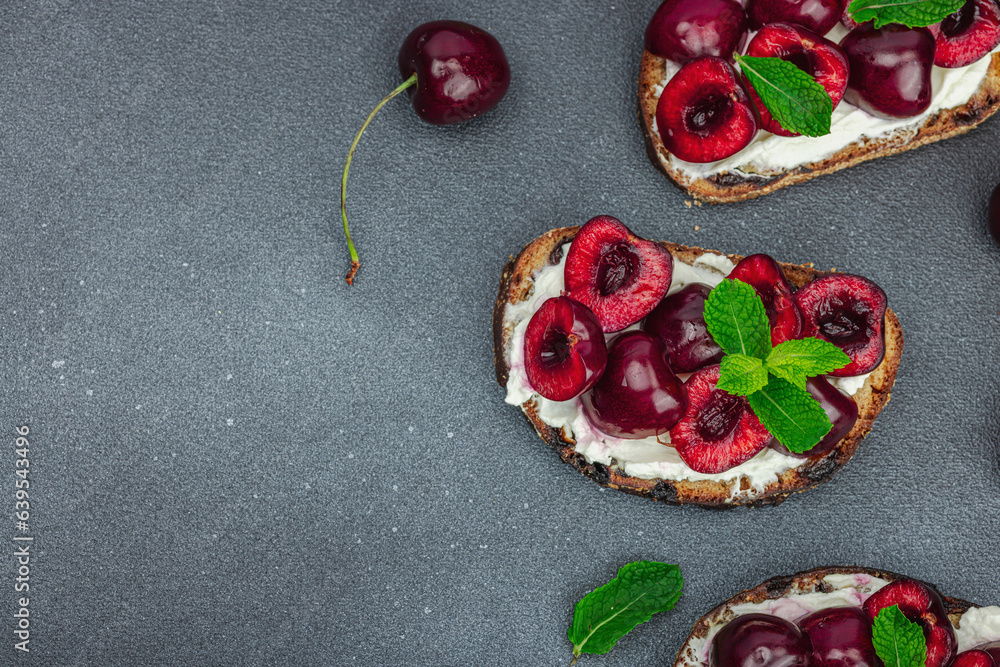 Fresh bread sandwiches with sweet cherry, cream cheese and mint leaves. Morning breakfast concept