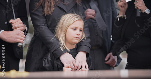 Fototapeta Child, sad and family at funeral at graveyard ceremony outdoor at burial place