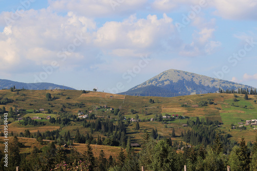 Landscapes of the Carpathian mountains and settlements. Travel concept. Hills  mountains  sky and clouds