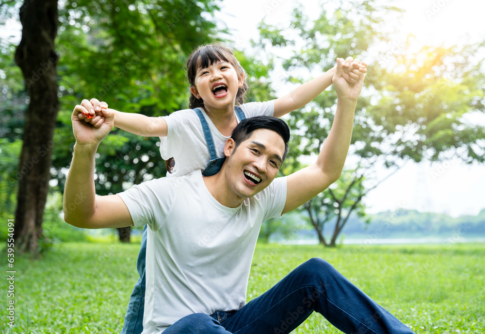 Obraz premium image of father and daughter playing in the park