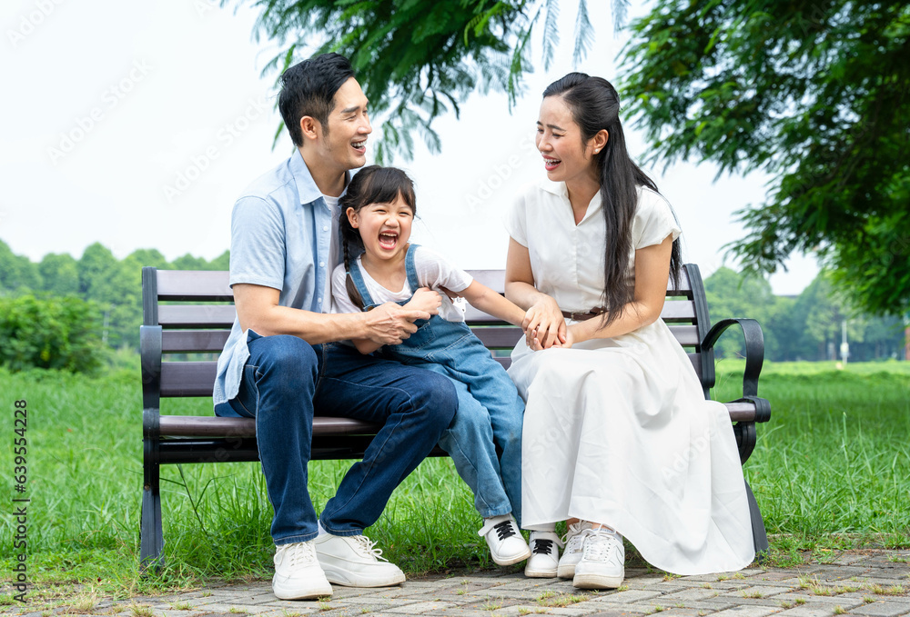 image of asian family playing in the park image of asian family playing in the park