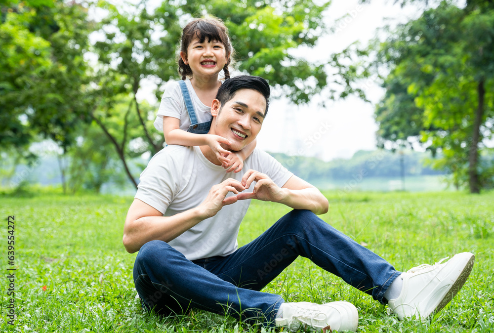 image of father and daughter playing in the park image of father and daughter playing in the park