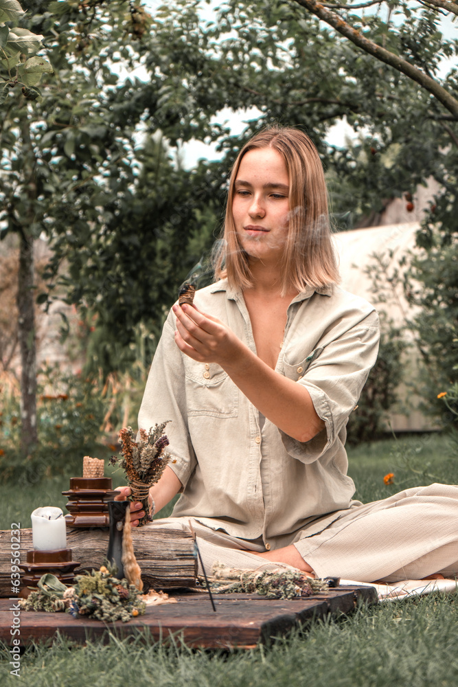 Woman Inhaling Incense Smoke During Meditation.Ground level of relaxed